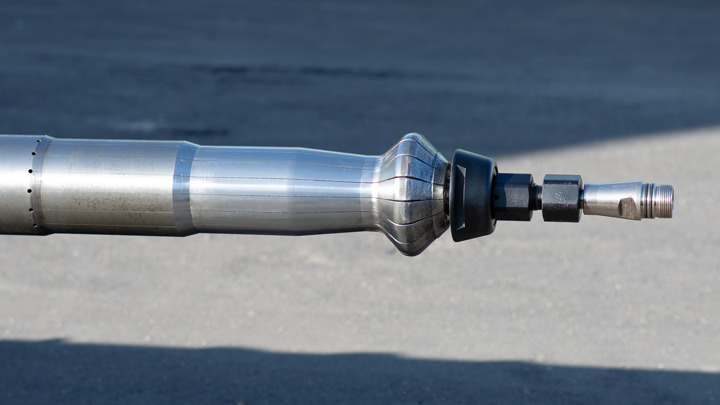 Close-up view of the Saturn Expander tool, designed to dent casing and densify cement to prevent gas leaks and support sustainable oil and gas production.