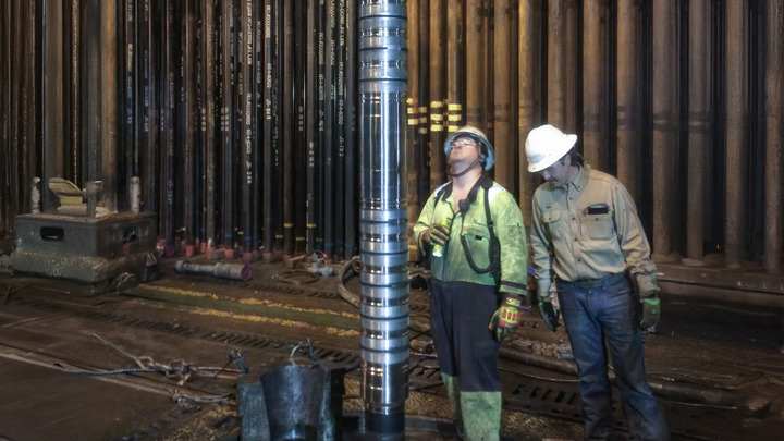 Engineers inspect WEA+WAB tool for high-force anchoring and zonal isolation in deepwater operation.