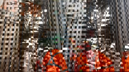 Cross-section of subsurface rock layers showing a Welltec tool deployed in the wellbore, highlighted with green rings for zone isolation.