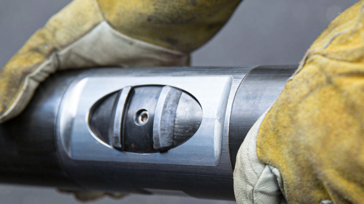 Close-up of tool with control module, enabling straddle placement across valve using Welltec solutions during well intervention.