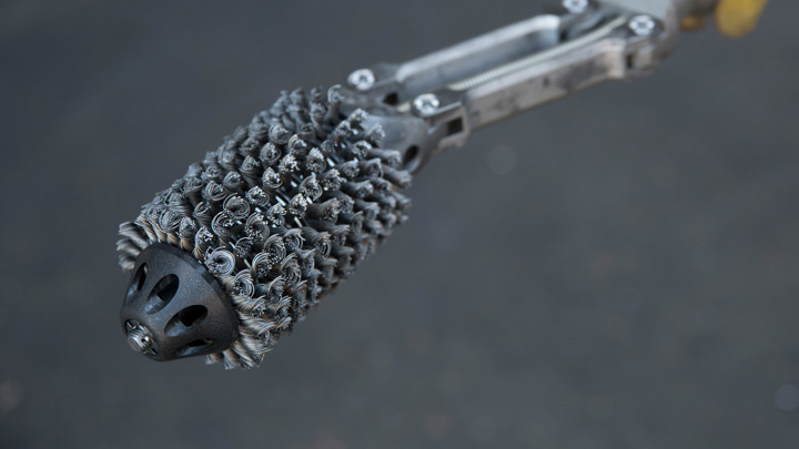 Close-up of downhole brush tool designed for cleaning barium sulfate scale from safety valve (SSSV).