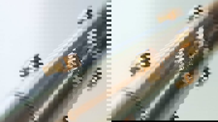 Close up of metallic tool with multiple rounded cutting elements for downhole intervention.