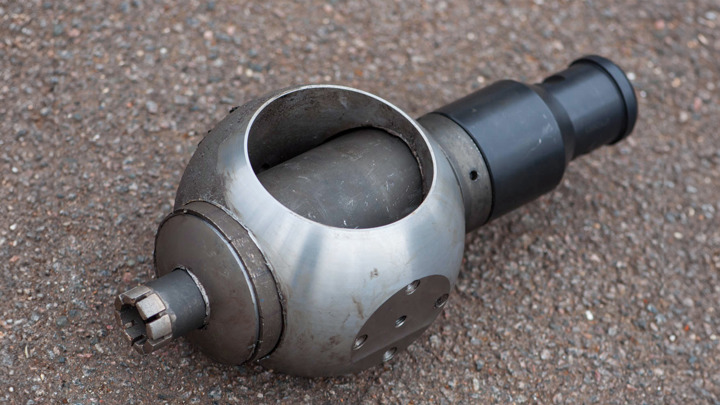 Close-up of a milled full isolation valve tool, used for downhole operations in the North Sea, resting on a rough surface.