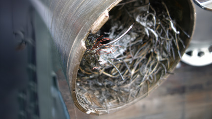Image showing the interior of a pipe filled with tangled wire, demonstrating Welltec novel fishing services.