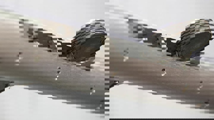 Close up of high temperature perforating intervention tractor showing wheel assembly for precise downhole navigation in challenging well conditions