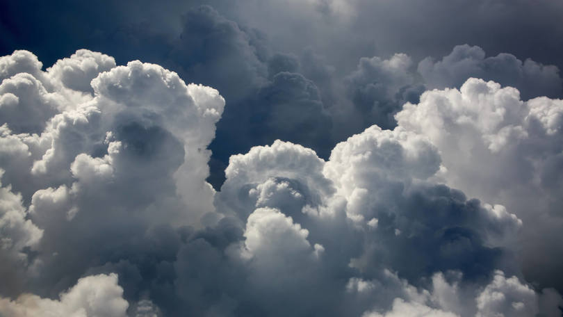 Dramatic clouds build up in the sky, creating a powerful and moody atmosphere before a potential storm.