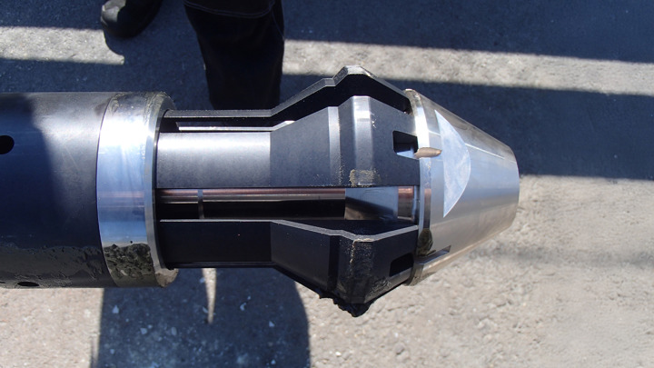 Close-up of a premium packer release tool on pavement, designed for plug and abandonment operations.